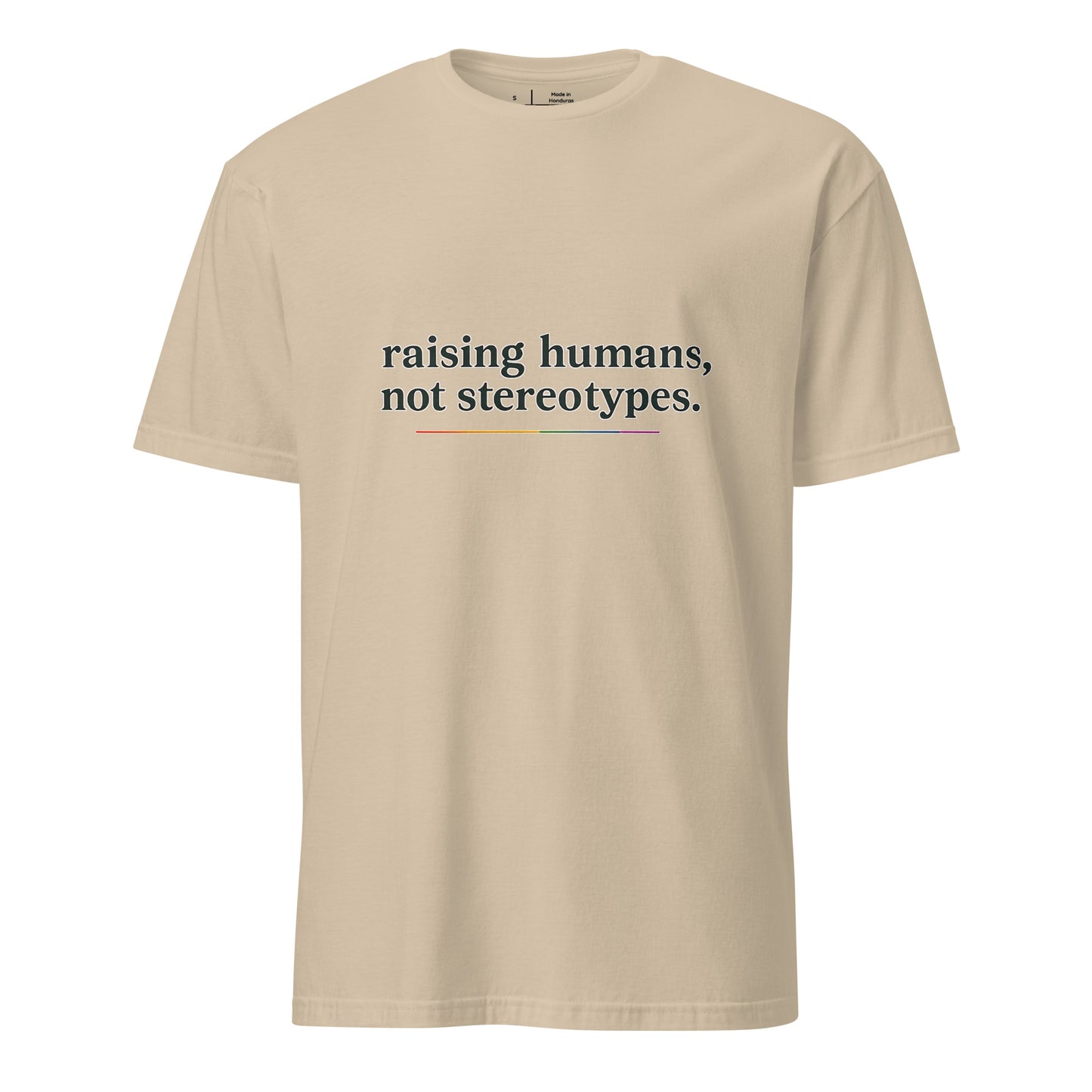 Raising Humans Not Stereotypes unisex pride tee in sand with rainbow-accented typography