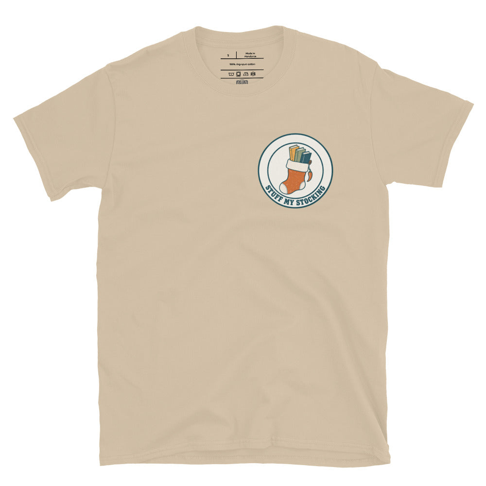 Stuff My Stocking unisex tee in sand with a Christmas stocking full of books and a chili pepper charm